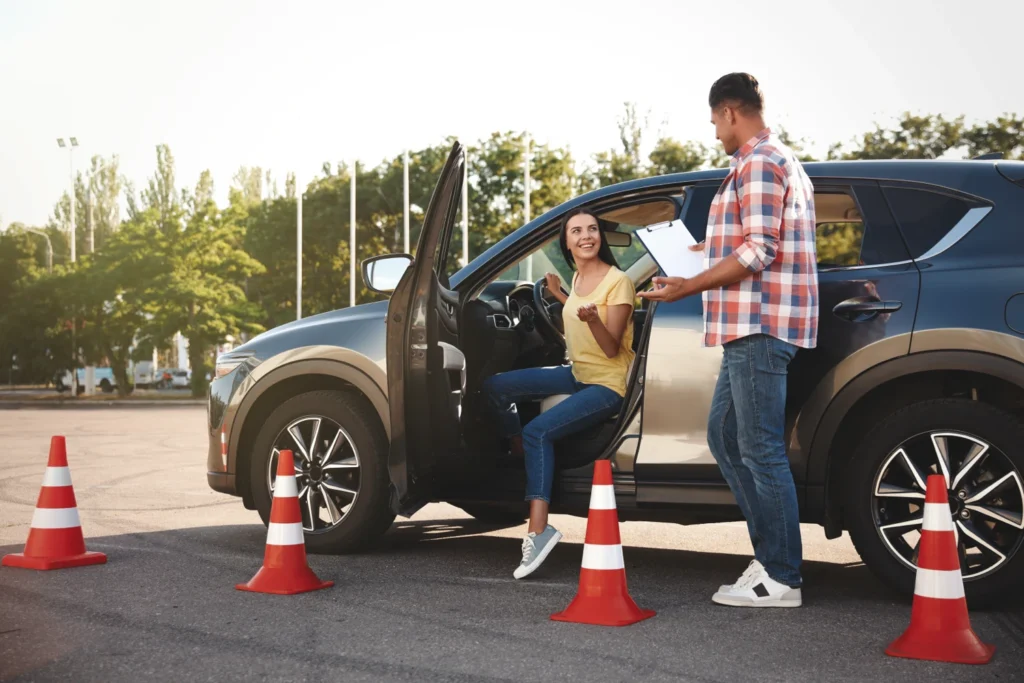 Driving student getting out of the car after doing a mock driving test with her instructor